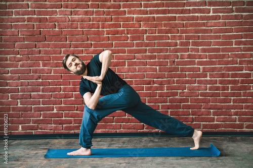 Fototapeta Naklejka Na Ścianę i Meble -  Handsome man doing yoga positions