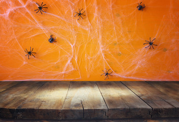 Empty rustic table in front of spider web background