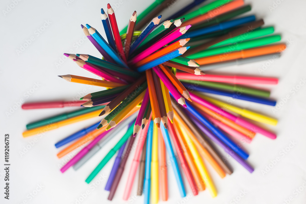 colored pencils and felt-tip pens on a white background colored pencils and felt-tip pens on a white background