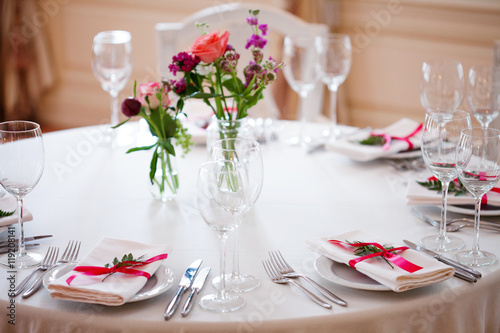 Wedding banquet, small restaurant floral, decor in red, informal style. © Ulia Koltyrina
