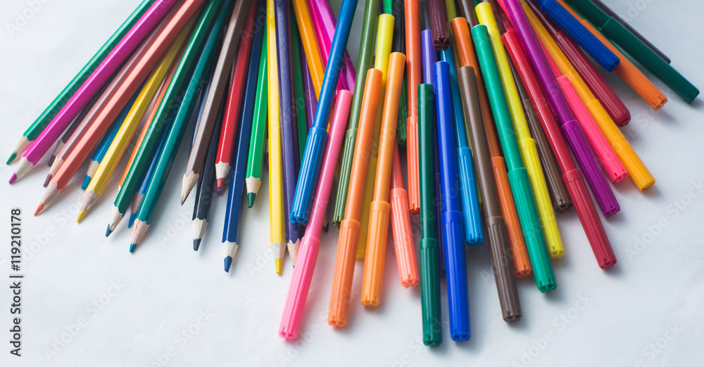 colored pencils and felt-tip pens on a white background colored pencils and felt-tip pens on a white background
