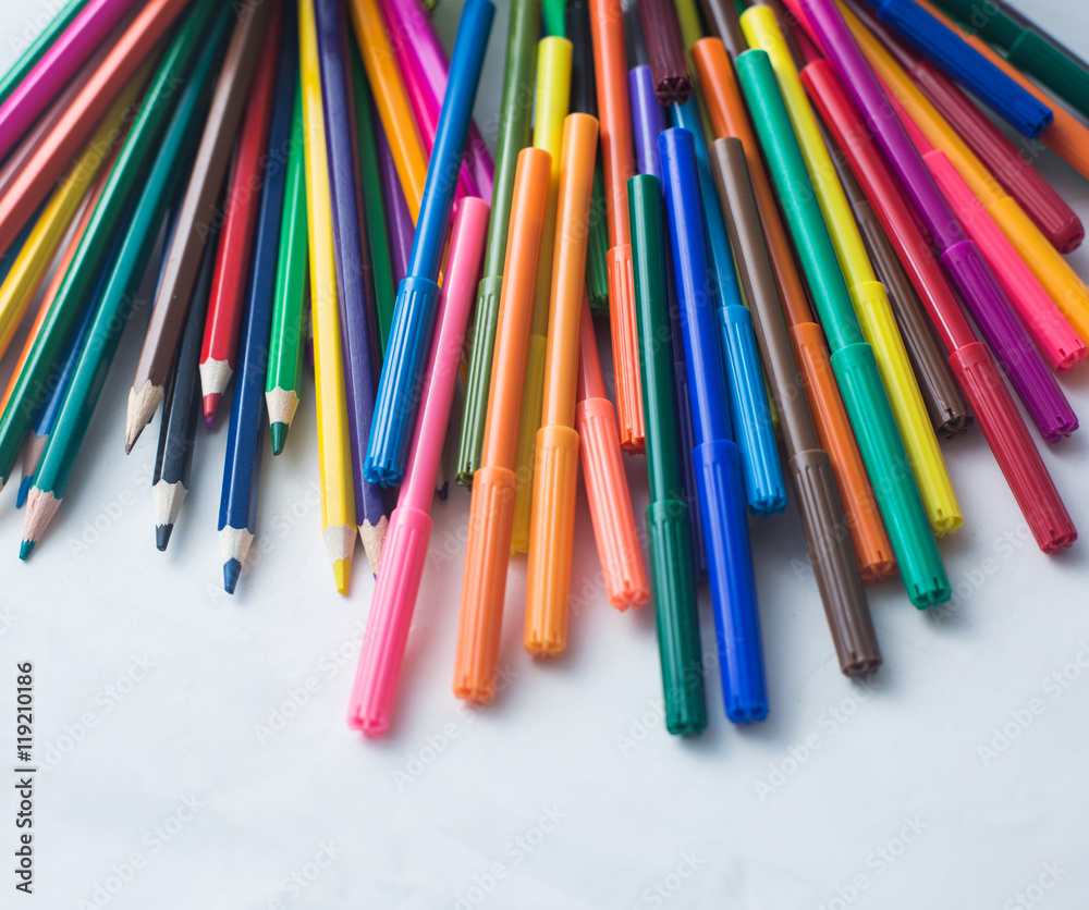 colored pencils and felt-tip pens on a white background colored pencils and felt-tip pens on a white background
