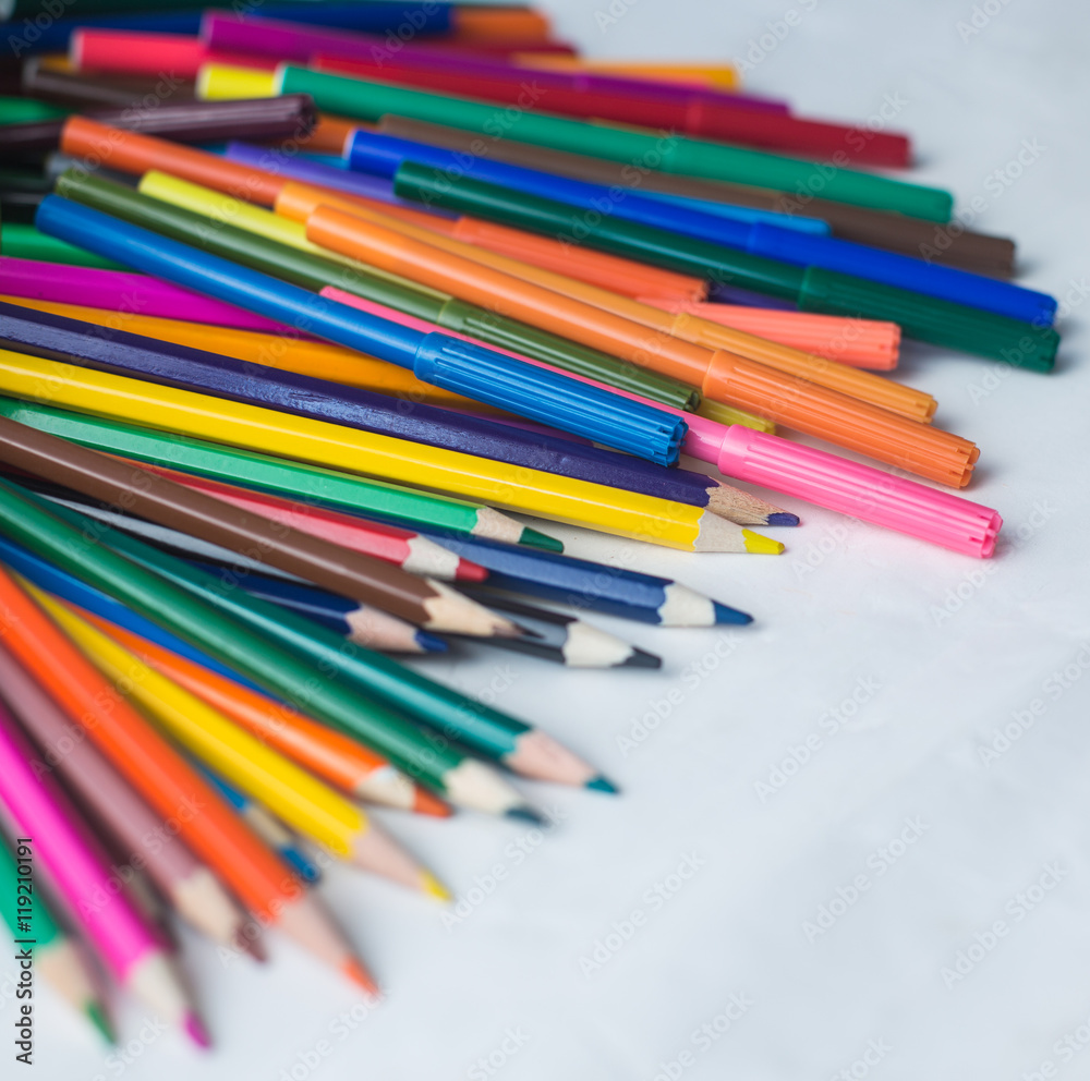 colored pencils and felt-tip pens on a white background colored pencils and felt-tip pens on a white background
