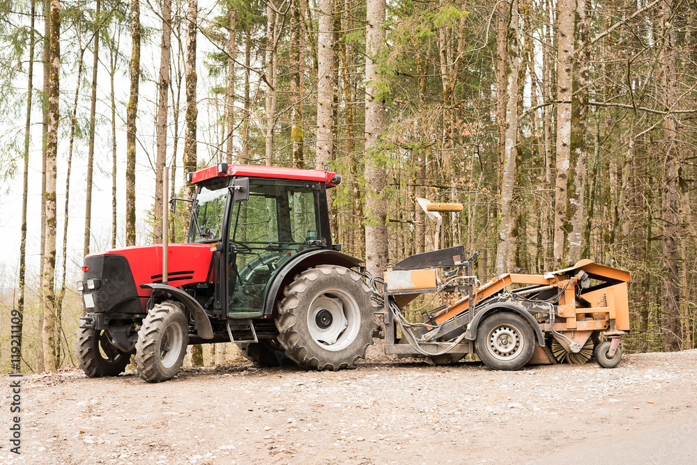 Tractor parked with trees in background Tractor parked with trees in background