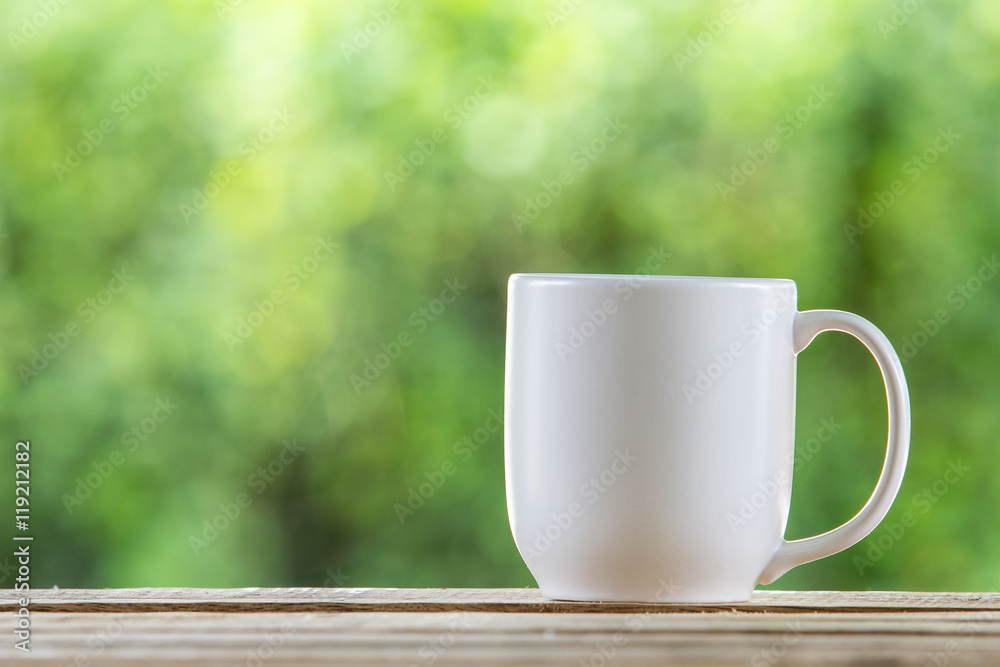 coffee mug wooden tabletop against grunge green blur background coffee mug wooden tabletop against grunge green blur background