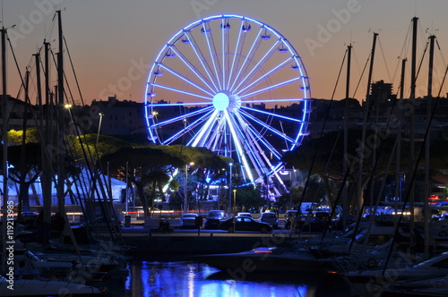 Night lights in the port of Antibes France, ferris wheel 