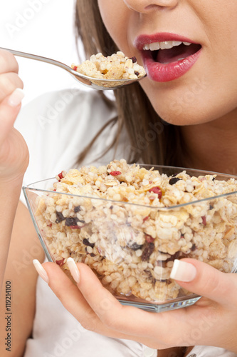 Young woman eating cereal breakfast