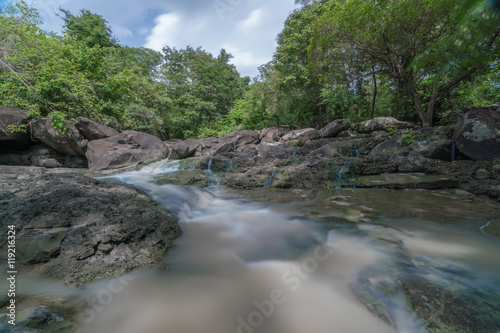 Deep forest waterfall with rocks in rainy season at Thailand - flowing cascade waterfall. Fantasy jungle landscape

