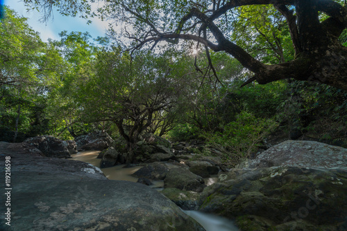 Sunray on Deep forest waterfall with rocks  in rainy season at Tadton waterfall National Park Thailand -  Fantasy jungle landscape  