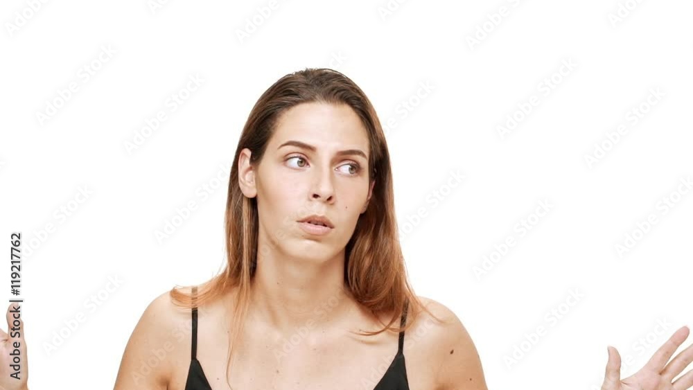 Displeased annoyed young beautiful girl gesturing over white background. Slow motion. Displeased annoyed young beautiful girl gesturing over white background. Slow motion.
