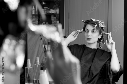 Beautiful woman is sitting in front of mirror