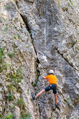 Mountaineer climbing Sohodol Gorges rocky slopes, in Gorj county, Romania