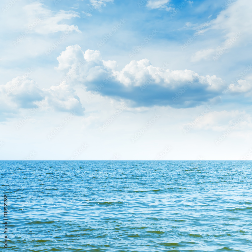 blue sea to horizon and clouds over it