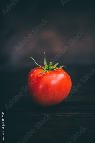 Tomate auf dunklen Holz