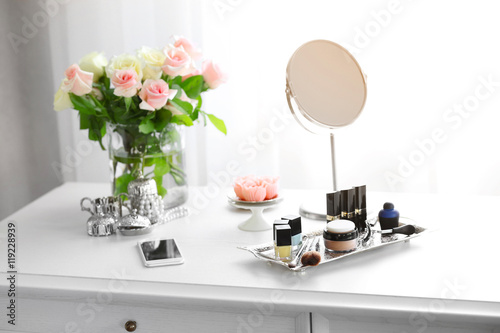 Cosmetic set on light dress...