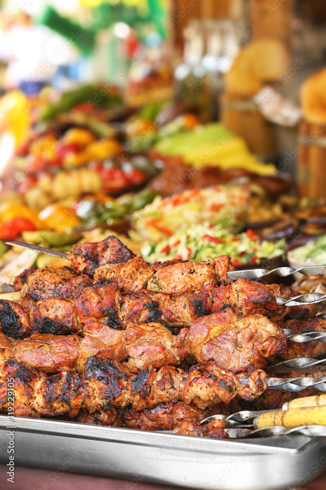 Barbecue skewers with juicy meat on tray