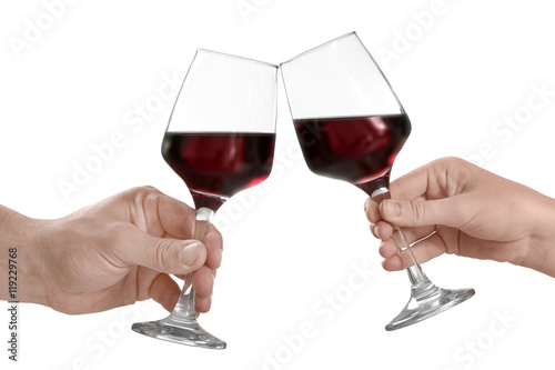 Hands with glasses of red wine, isolated on white