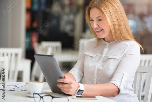 Cheerful woman sitting at the table