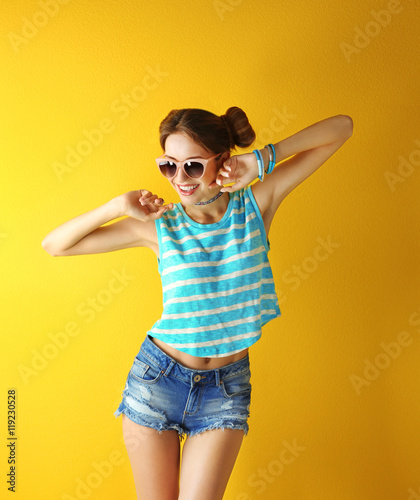 Beautiful girl on yellow ba...