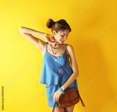 Beautiful girl on yellow ba...