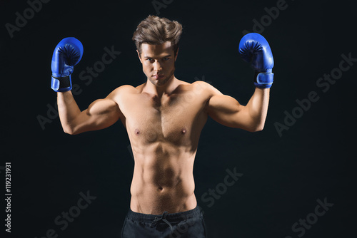 Serious male boxer showing his biceps © Yakobchuk Olena