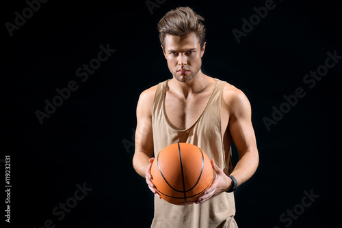 Cheerful young man playing basketball © Yakobchuk Olena