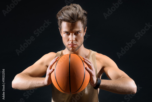 Fit young man playing basketball