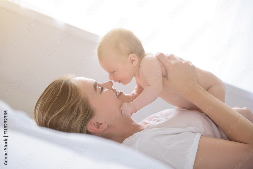 Happy mother holding up her baby girl Happy mother holding up her baby girl