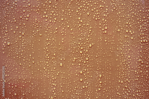 Water drop on brown background.