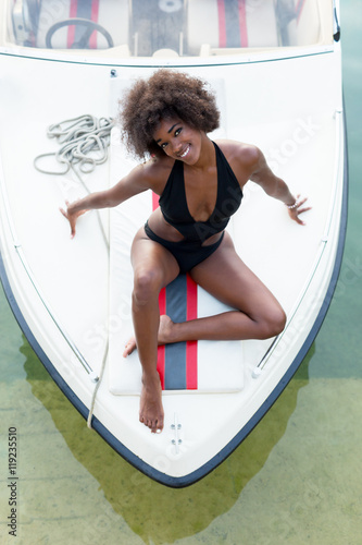 afro woman relaxing on a speedboat. photo