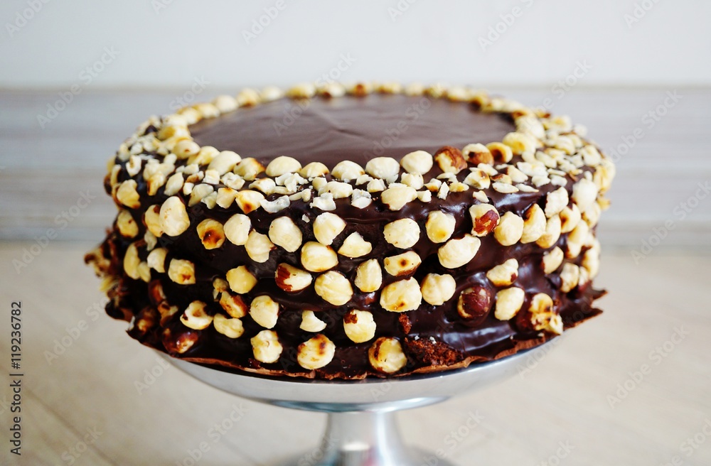 A vegan chocolate and hazelnut cake on a pedestal