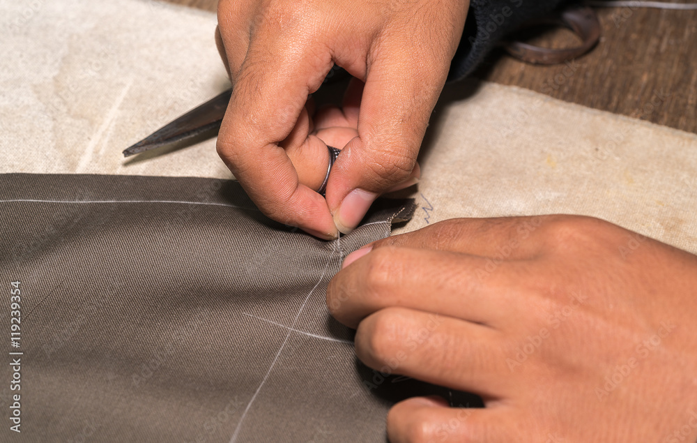 Obraz premium Production process of suit tailoring, hand sewing of a tailored jacket 