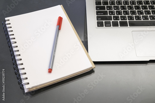 Office desk table with computer, supplies, coffee cup on wooden