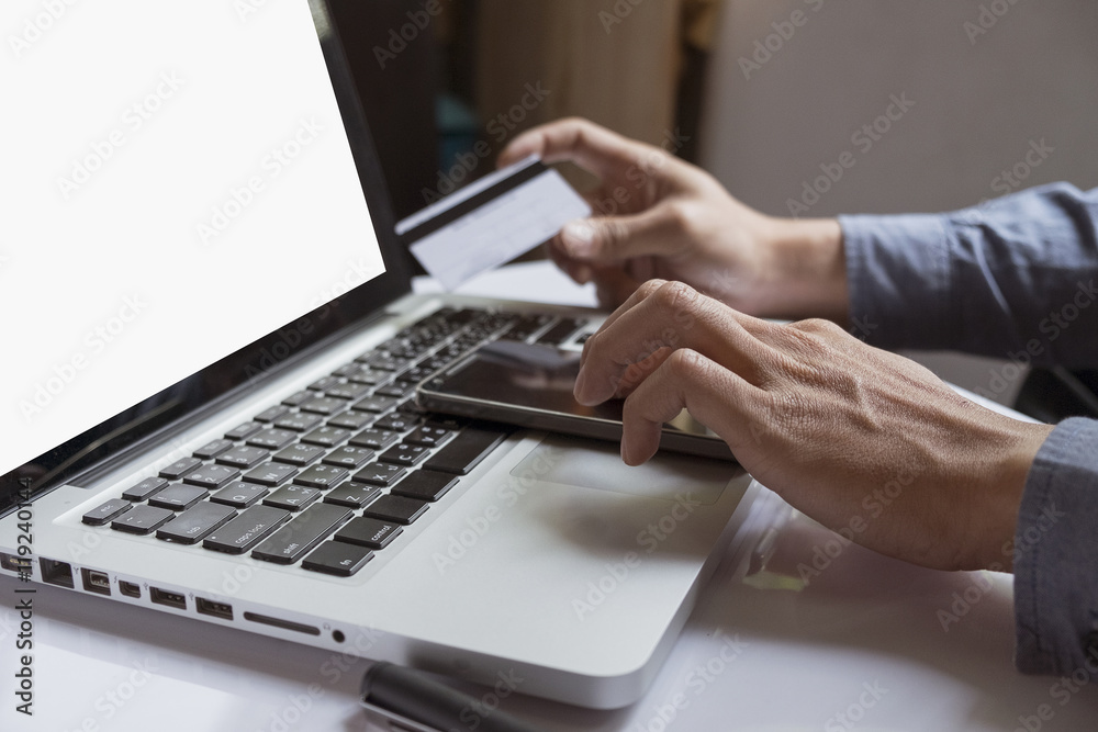 man's hands holding credit card and using laptop. Online shopping man's hands holding credit card and using laptop. Online shopping