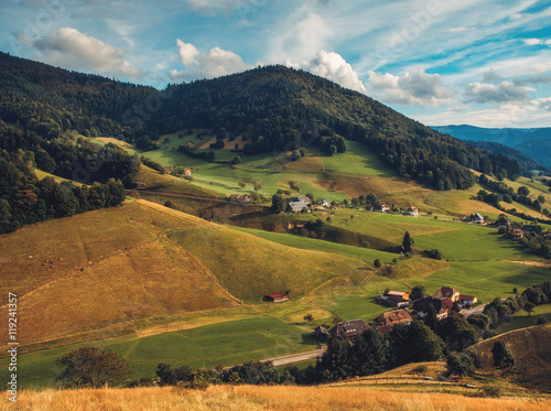 Scenic countryside landscape: mountain valley with forests, fields and old houses in Germany, Black Forest