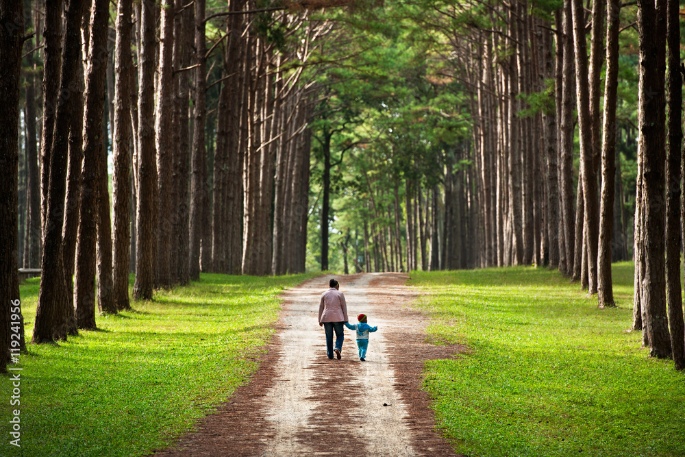 Fototapeta premium Mother and baby walk on country rural road