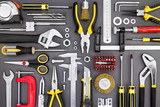 various working tools on grey table background. drills, wrenches