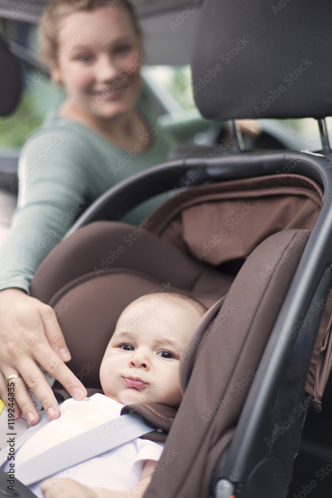 Mother checking on baby while in the car Mother checking on baby while in the car