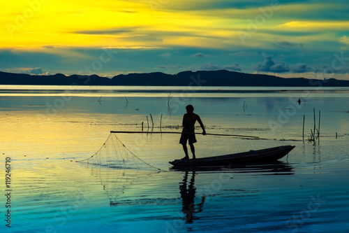 Beautiful sky and Silhouettes of fisherman. © noppharat