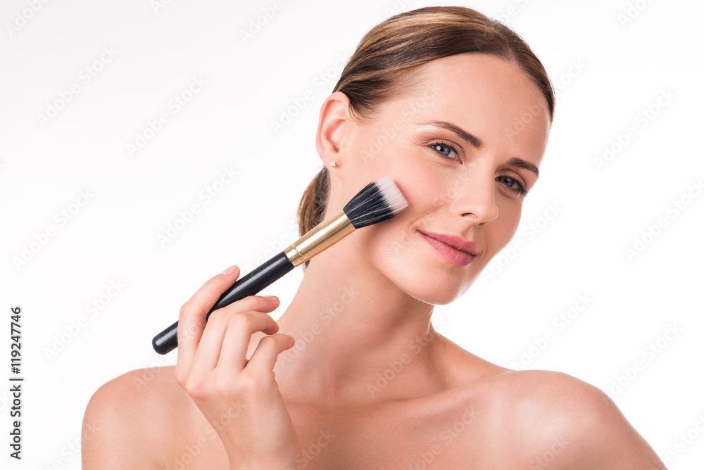 Pretty young woman holding makeup brush Pretty young woman holding makeup brush
