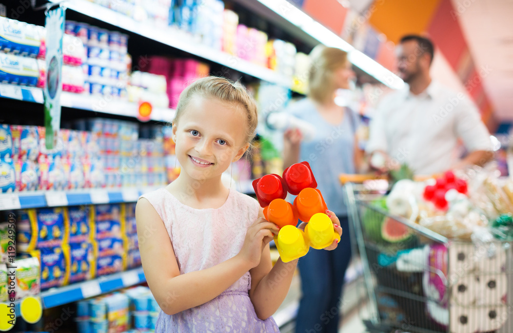 Girl holding package with yogurt