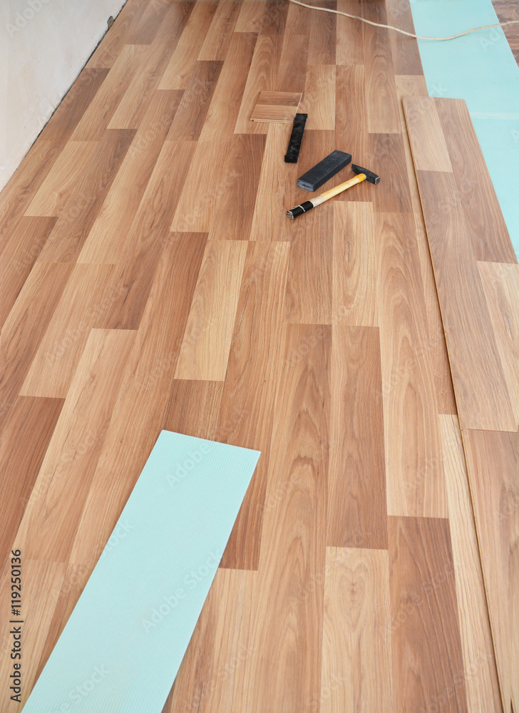  Installing wooden laminate flooring.