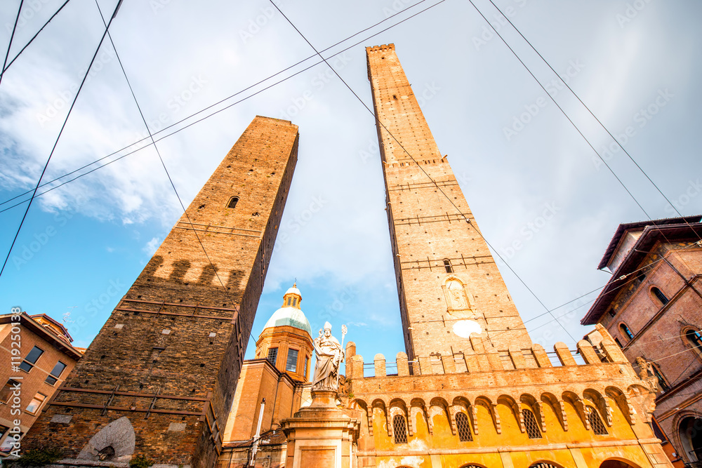 Two famous leaning towers and Petronius statue in Bologna city. Bologna's two leaning towers are the city's main symbol