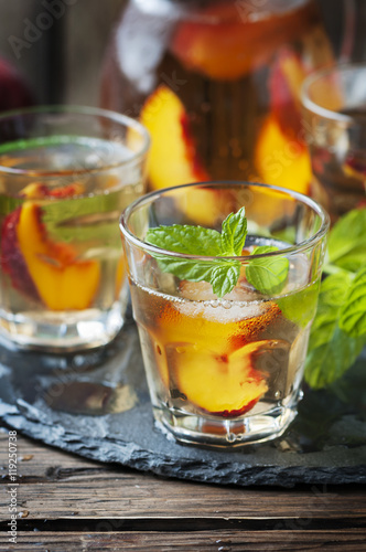 Cold healthy tea with peaches and mint