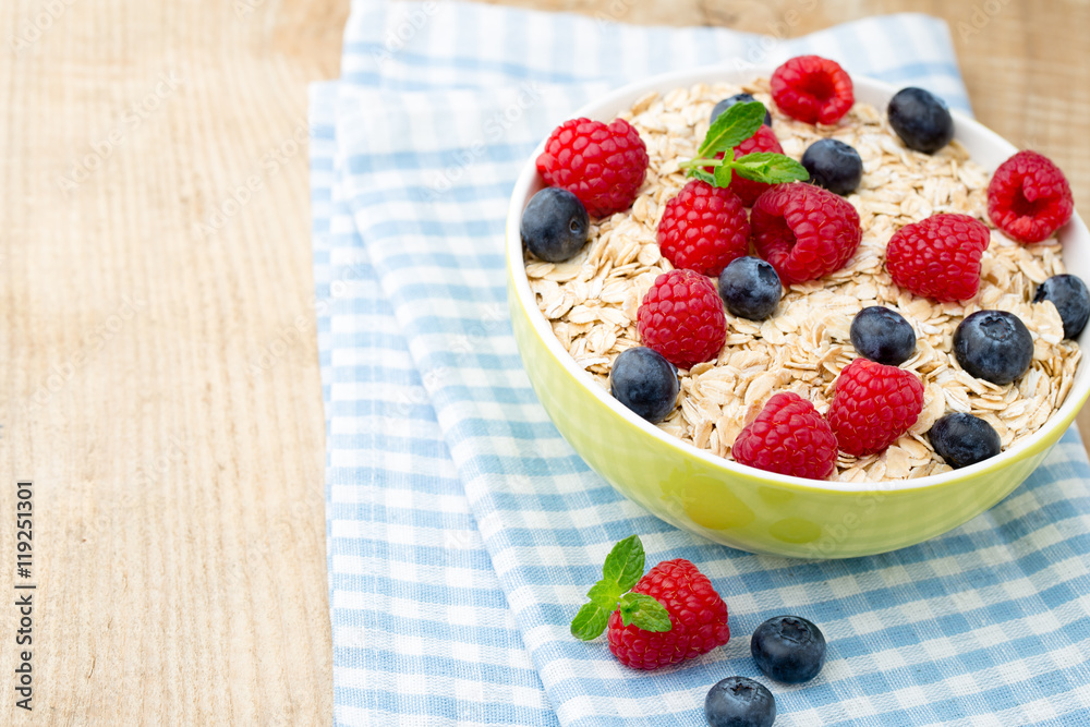 Oatmeal porridge with berries. Raspberries and blueberries. Oatmeal porridge with berries. Raspberries and blueberries.