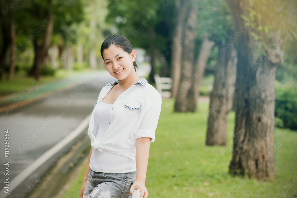 Young asian woman relaxing outdoors looking happy and smiling Young asian woman relaxing outdoors looking happy and smiling