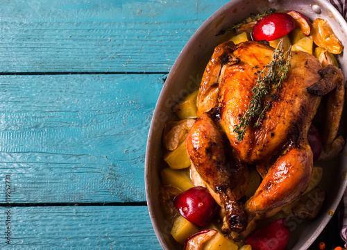 Homemade Roasted Thanksgiving Day Turkey on bright blue wooden background.