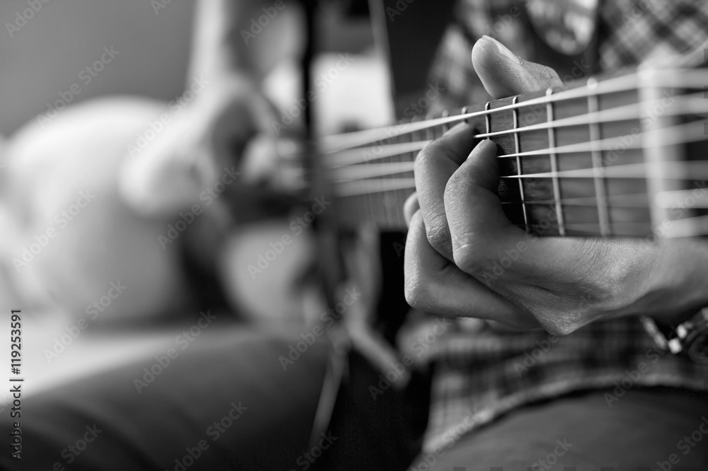 Fototapeta premium playing acoustic guitar, barre chord,selective focus,black and w