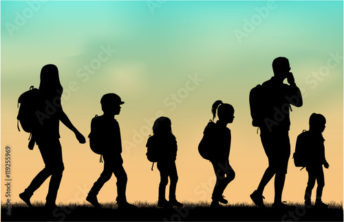 Family reaching with backpacks on a trip.