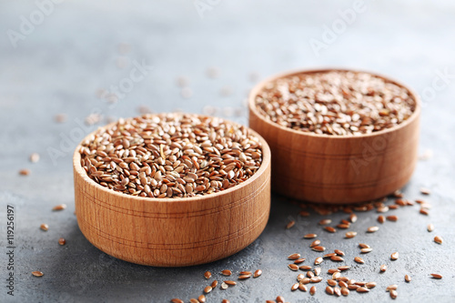 Brown flax seeds on grey wooden table